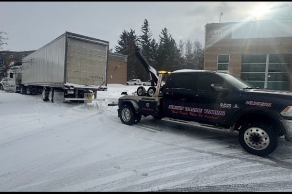 Budget Barrie Towing winching a vehicle in deep snow in Barrie